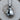 Close-up of the vintage-style boxing gloves pendant resting on a wooden log highlighting the premium silver texture