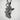 Praying Baby Angel Pendant, angled profile view against textured wall
