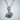 Rose Thorn Pendant, polished, front view against wall