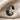 Close-up of ancient Anatolian winged griffin engraving on 925 silver ear cuff displayed on beige linen