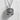 Close-up front view of the sterling silver Daruma doll pendant highlighting the intricate oxidized facial metalwork.