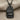 Teshub Storm God Pendant, black rhodium finish, front view on fabric