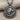 Close-up of ancient coin pendant showing the roaring lion relief and hammered sterling silver textured border