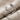 Detailed close-up of the 925 silver deer antler ring on textured fabric, revealing brushed matte finish and oxidation.
