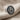 Detailed view of the Lydian stater inspired lion coin stud earring highlighting the silver beading and gold lion profile.