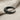 Close-up of the bull horn ear cuff highlighting the deep oxidation in the base grooves against a textured fabric