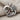Mother holding baby pendant in oxidized silver, angled view on fabric