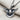 Close-up of handcrafted silver dove pendant resting on textured linen fabric highlighting its oxidized finish