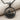 Sailboat Wave Pendant, black rhodium plated, front view on fabric