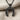 Inverted Horseshoe Pendant, black rhodium, on chain against fabric background