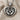 Close-up of the handcrafted baby feet necklace showing the detailed footprint design and oxidized silver finish on fabric