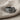 Close-up of the Sagittarius constellation ring resting on textured linen fabric highlighting the silver details.