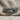 Close-up of the oxidized silver lion family ring displayed on textured fabric, highlighting the animal engravings