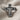 Close-up of artisan handcrafted Jesus cross ring resting on linen fabric highlighting intricate silver carving.