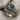 Close-up of Saint George ring with detailed dragon scales and engraved faith and courage text on the side band