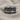 Close-up of artisan Last Supper silver ring displayed on textured beige linen background showing rich details