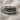 Close-up shot of Last Supper ring resting on textured linen fabric background displaying antique finish
