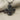 Detailed close-up of oxidized sterling silver Celtic cross pendant resting on natural textured linen cloth