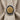 Close-up detail of a gold rose signet ring resting on a textured linen napkin background showing top-down angle