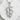 Close-up view of oxidized silver Rod of Asclepius pendant lying on a white textured stone surface