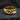 Close-up of handcrafted sterling silver ring showing sharp architectural details and oxidized depth