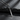 Angled view of silver sword necklace highlighting the oxidized finish and sharp blade profile