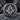 Masonic G Square Compass Ring, oxidized finish, front view on rock surface