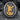 Saint Michael Battle Signet Ring, two-tone finish, front view on rock surface