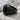 First Division Onyx Signet Ring, black rhodium, angled side view on rock
