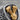 Close-up detail of the gold vermeil V-twin engine motif and flame engravings on oxidized silver ring