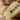 Close-up of hand-finished details and turquoise lapis gemstones on Egyptian queen crown profile pendant