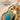 Detailed close-up shot of hand-finished scarab beetle pendant showcasing carved wings and turquoise setting