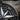 Extreme macro close-up of compass pendant showing hand-finished NE direction lettering and textured oxidized silver