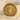 Medusa Head Ring in gold vermeil, front view on sand