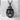 Hatching Dragon Egg Pendant, black rhodium, product photo on stone block