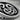 Close-up macro detail of hand-finished three headed dragon crest knotwork on oxidized sterling silver lapel pin