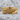 Volcanic Lava Ring, gold vermeil, front view resting on rock