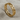 Eternity interlinked heart ring in gold vermeil, angled front view on fabric