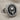 Hittite Sun Disk Earring, oxidized silver, angled front view