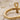 Close-up view of authentic 925 hallmark stamp engraved inside silver ankh ring band resting on fine white sand
