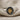 Hittite Sun Disk Ring, two-tone, product photo on linen