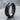 Arrow Spinner Ring, black rhodium, angled view on stone surface