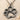 Paw Print Pendant, oxidized silver, front view on sand
