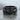 Intertwined Skull Ring, black rhodium, front view on stone surface