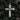 Polished silver western style cross pendant with rope circle design displayed on dark textured rocks