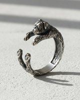 Angled close-up of sterling silver bulldog ring highlighting oxidized finish and intricate animal jewelry design