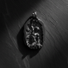 Black rhodium plated silver self made man pendant showing figure carving himself from stone