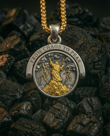 Silver Stormborn Climber Pendant's 'Chaos' side, featuring a gold-plated figure on a peak with lightning bolts.