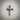 Angled view of textured silver cross necklace pendant highlighting heavy oxidation and artisan craftsmanship