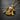 Side-view of the gold-plated hooded skull necklace, highlighting the 3D craftsmanship and polished finish against a stone surface.